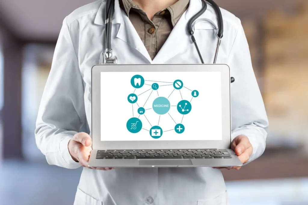 Doctor showcasing a laptop screen with healthcare icons and digital medical medication